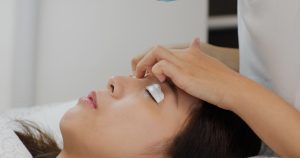 Woman perm eyelashes at beauty salon